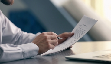 man holding a pen and paper